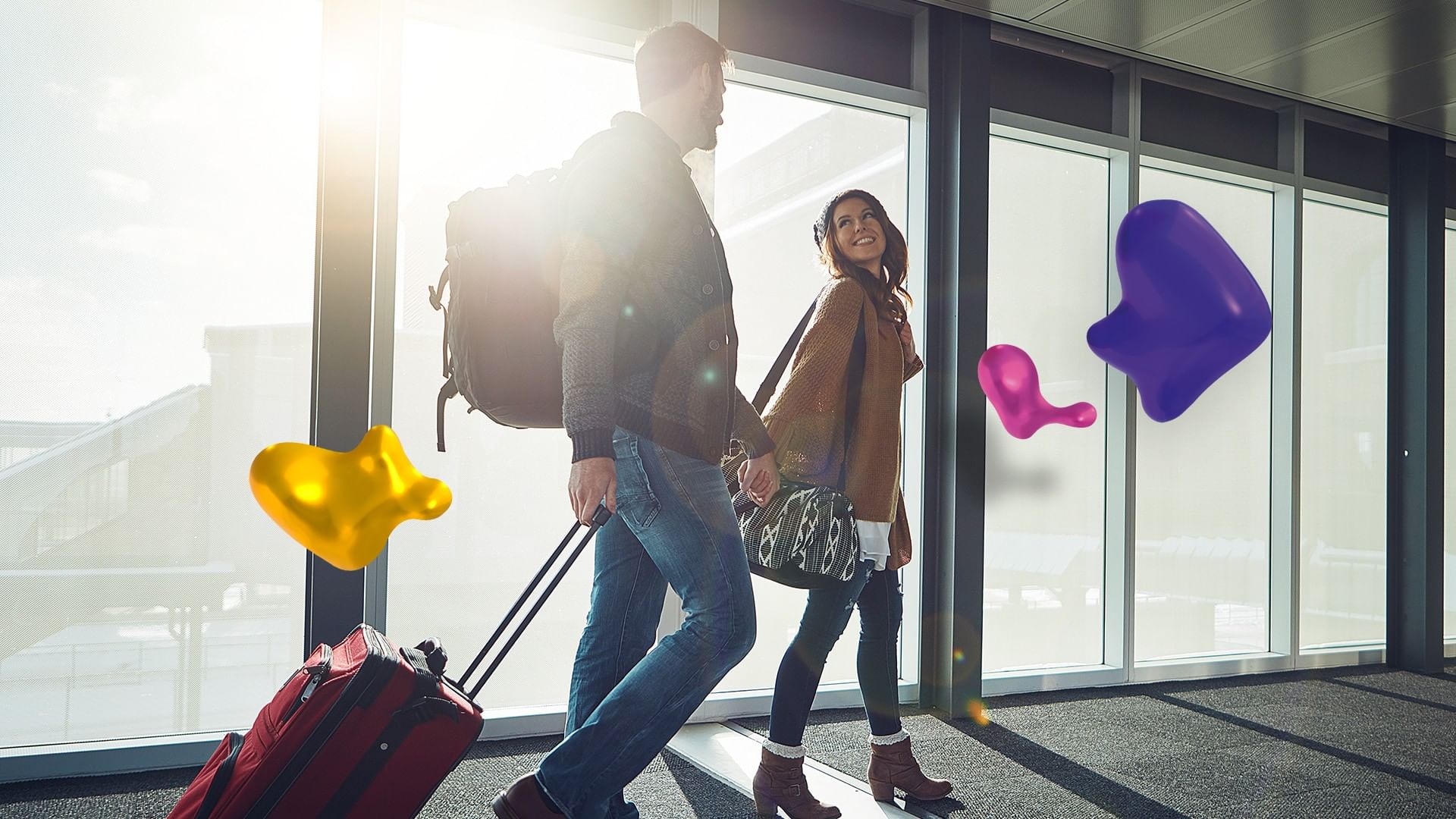 Young couple walking through a bright airport terminal with travel luggage at Camino Real Aeropuerto Mexico