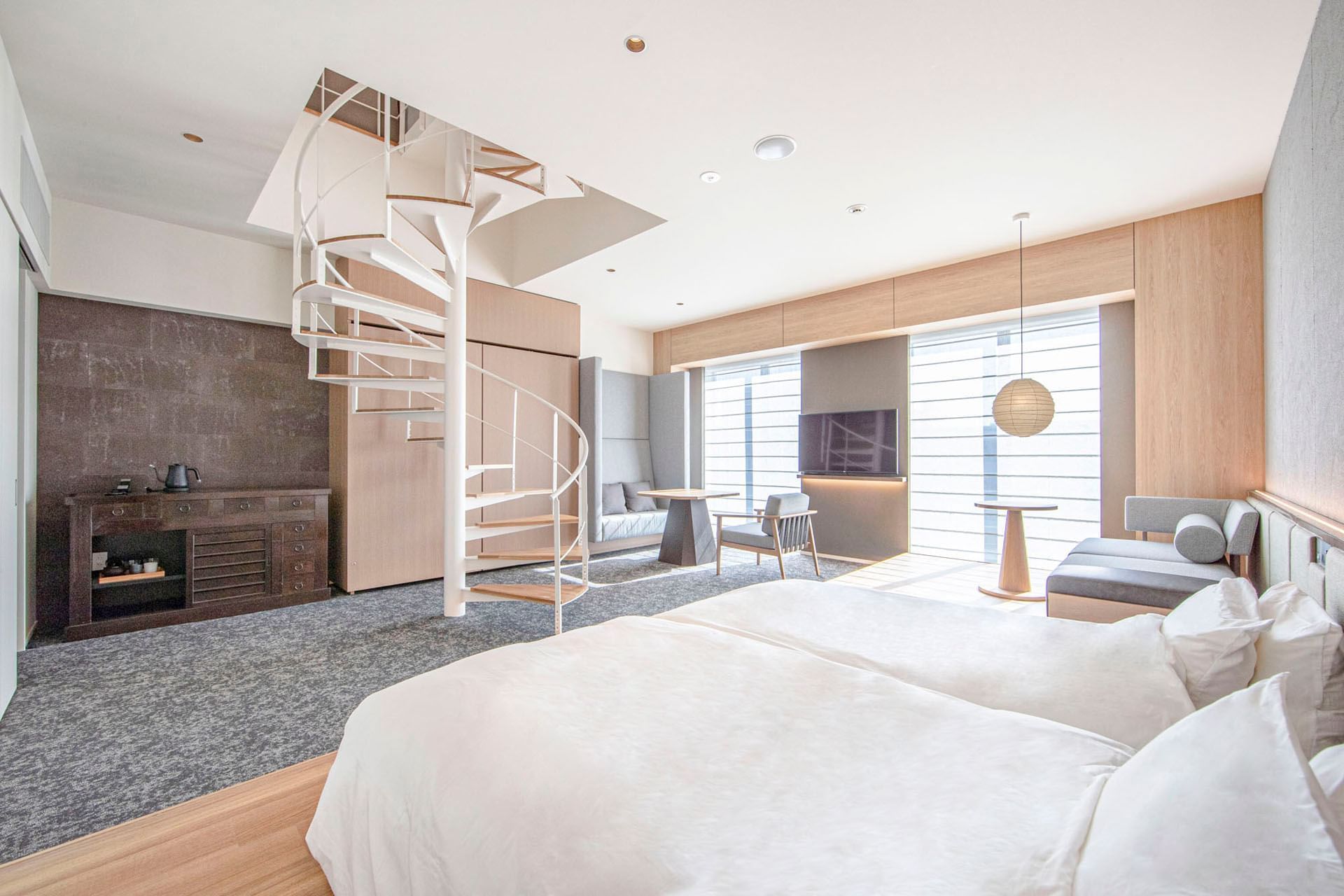 Comfy beds, spiral staircase and lounge area in Park Suite at Park Hotel Kyoto