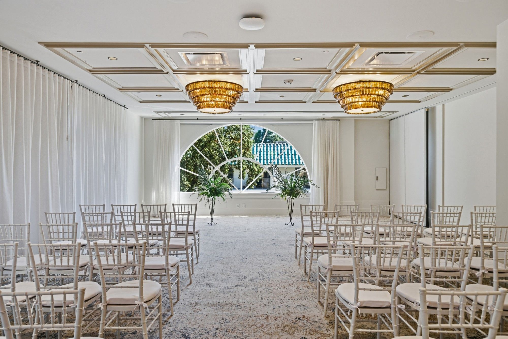 Chairs arranged in rows face an archway at El Prado Palo Alto