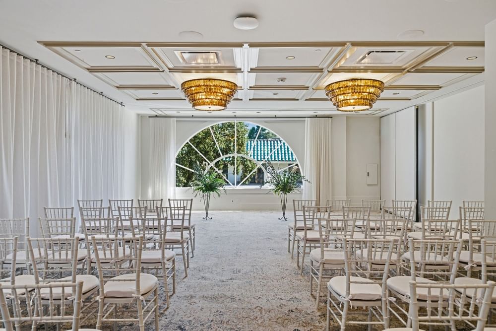 Chairs arranged in rows face an archway at El Prado Palo Alto