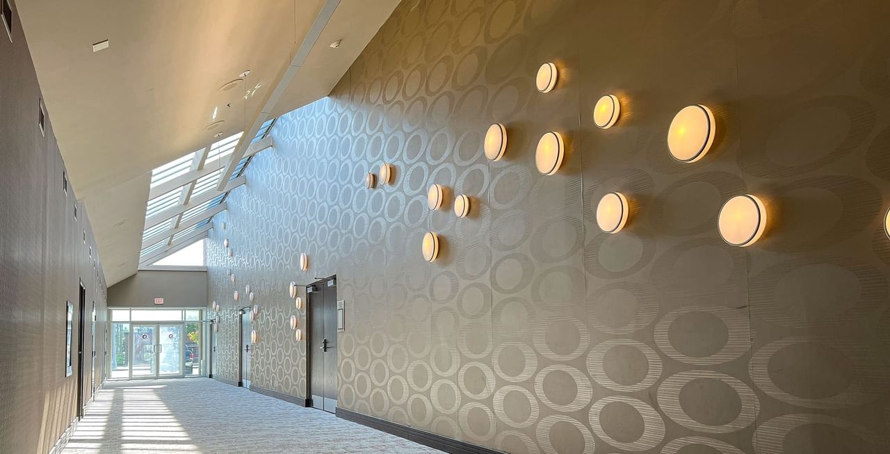 Hallway of a hotel with lights and doors