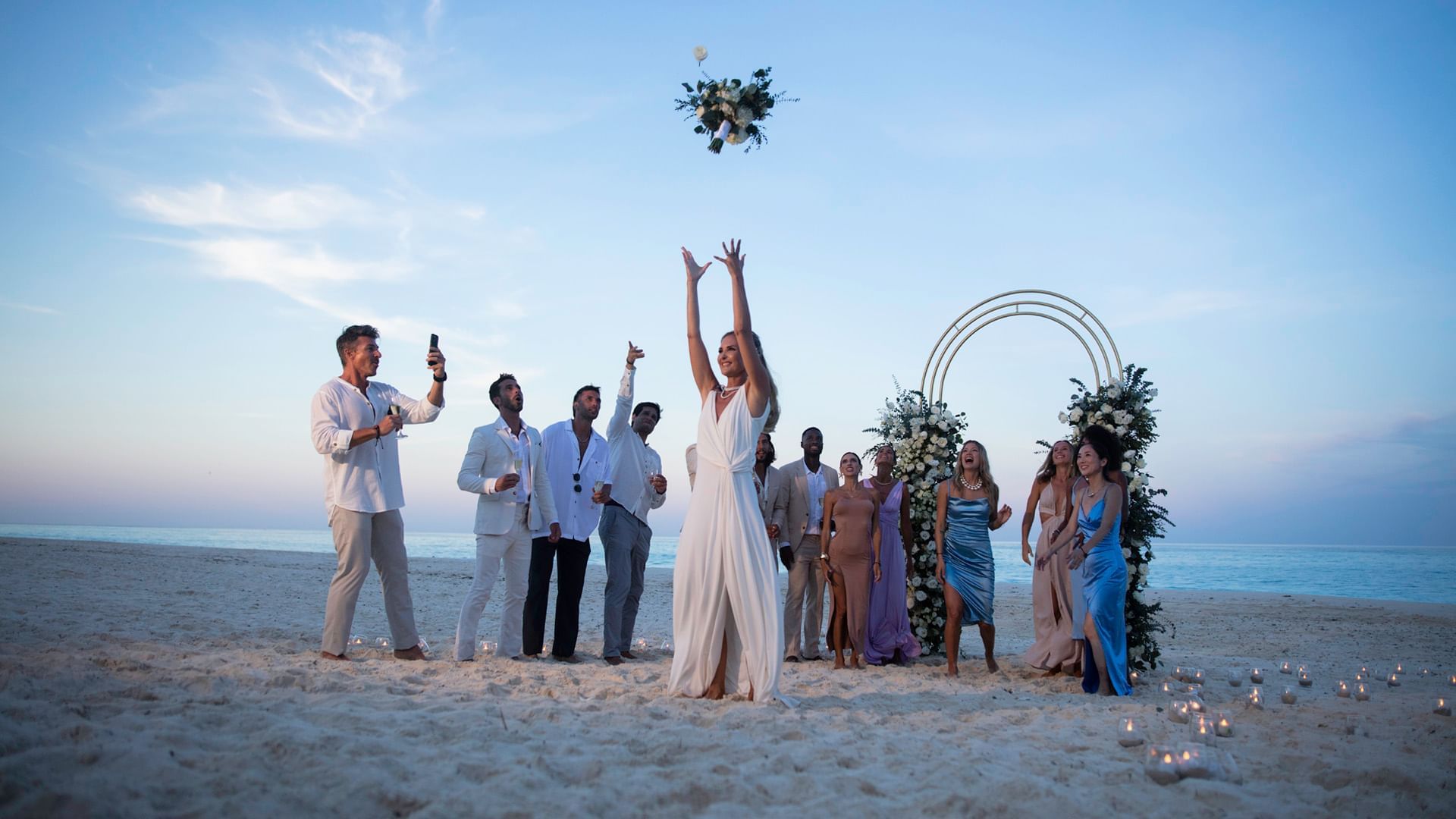 Wedding ceremony scene with guests on beach near Live Aqua Resorts and Residence Club