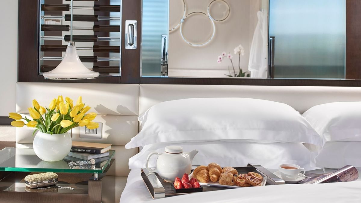 Close-up of breakfast served on a bed at Crown Hotels