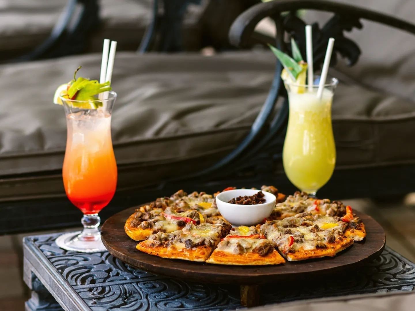 Plate of pizza and two tropical drinks at Pool Bar, Dar Es Salaam Serena Hotel, Dar es Salaam.