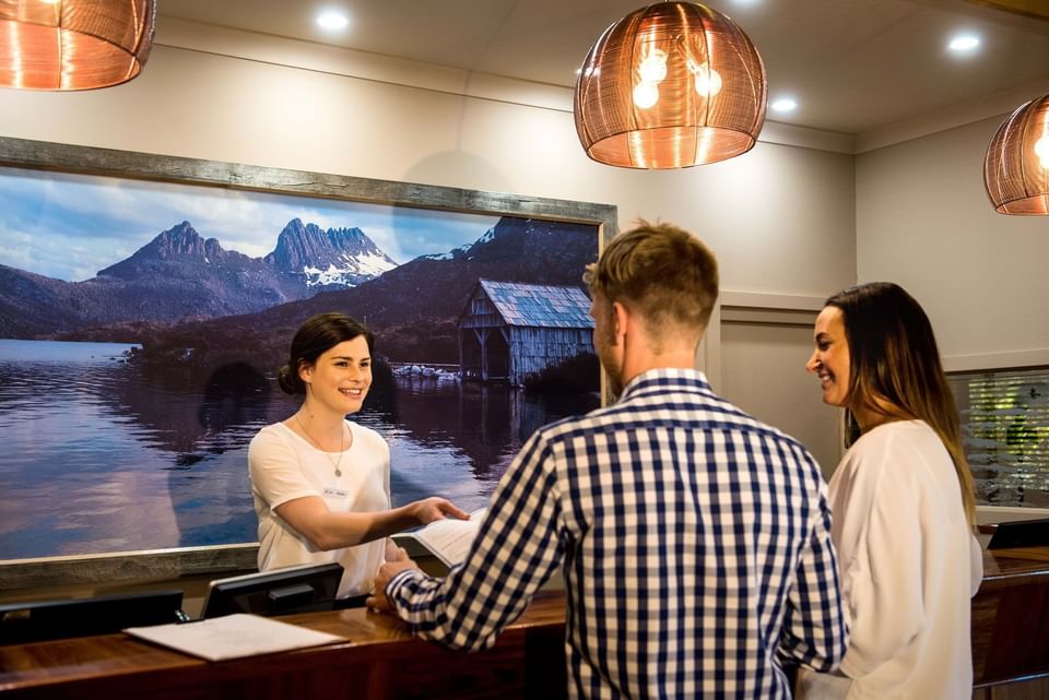 Couple checking in by the front desk at Cradle Mountain Hotel