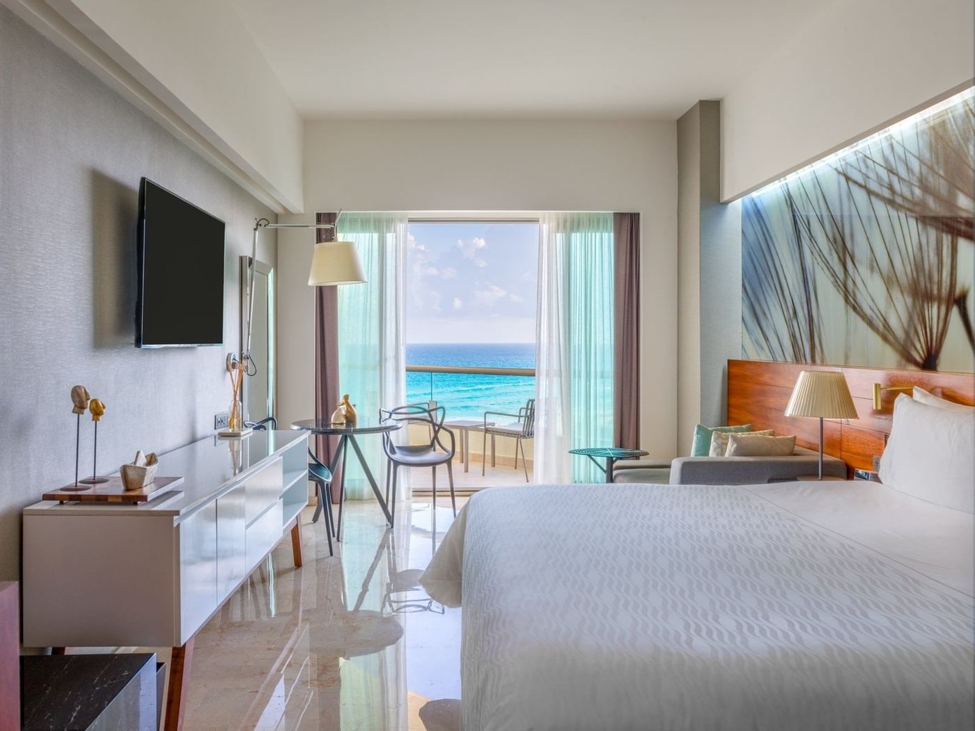 Premium Ocean View with a balcony and king bed faced by TV at Live Aqua Beach Resort Cancun