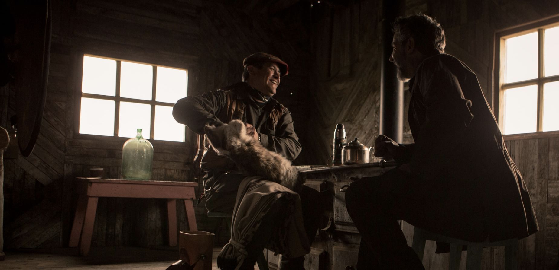 Two men talking at a table at The Singular Patagonia