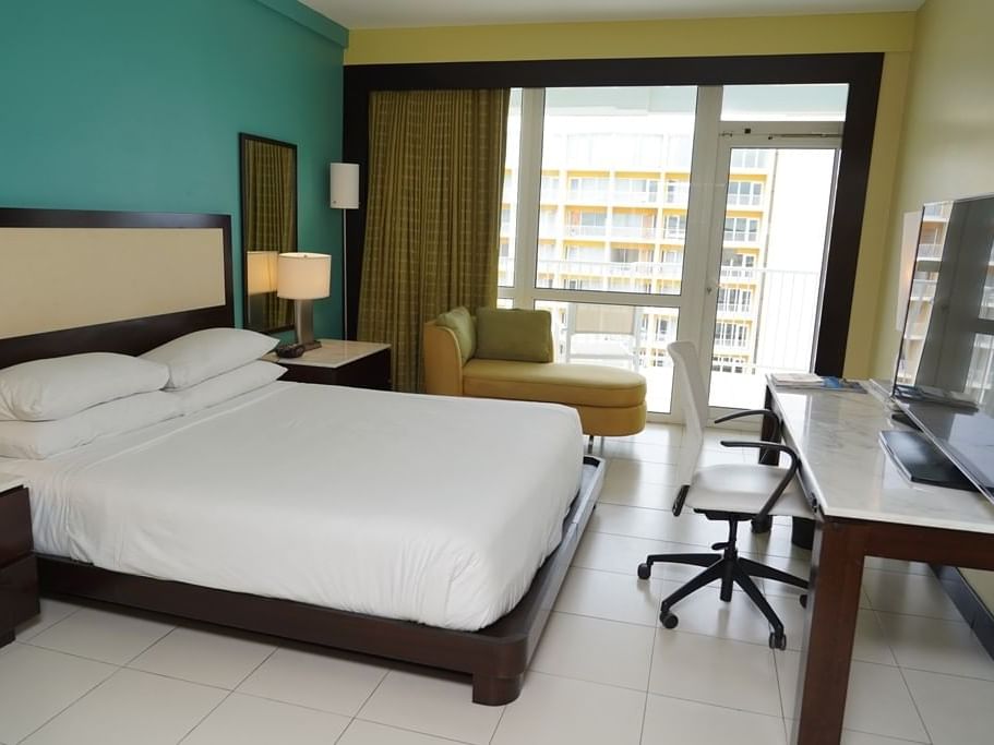 King Bed with furniture in a Standard Room at Condado Plaza 