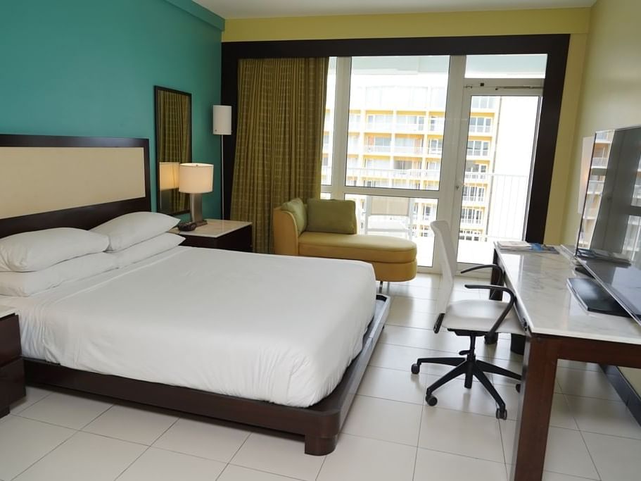 King Bed with furniture in a Standard Room at Condado Plaza