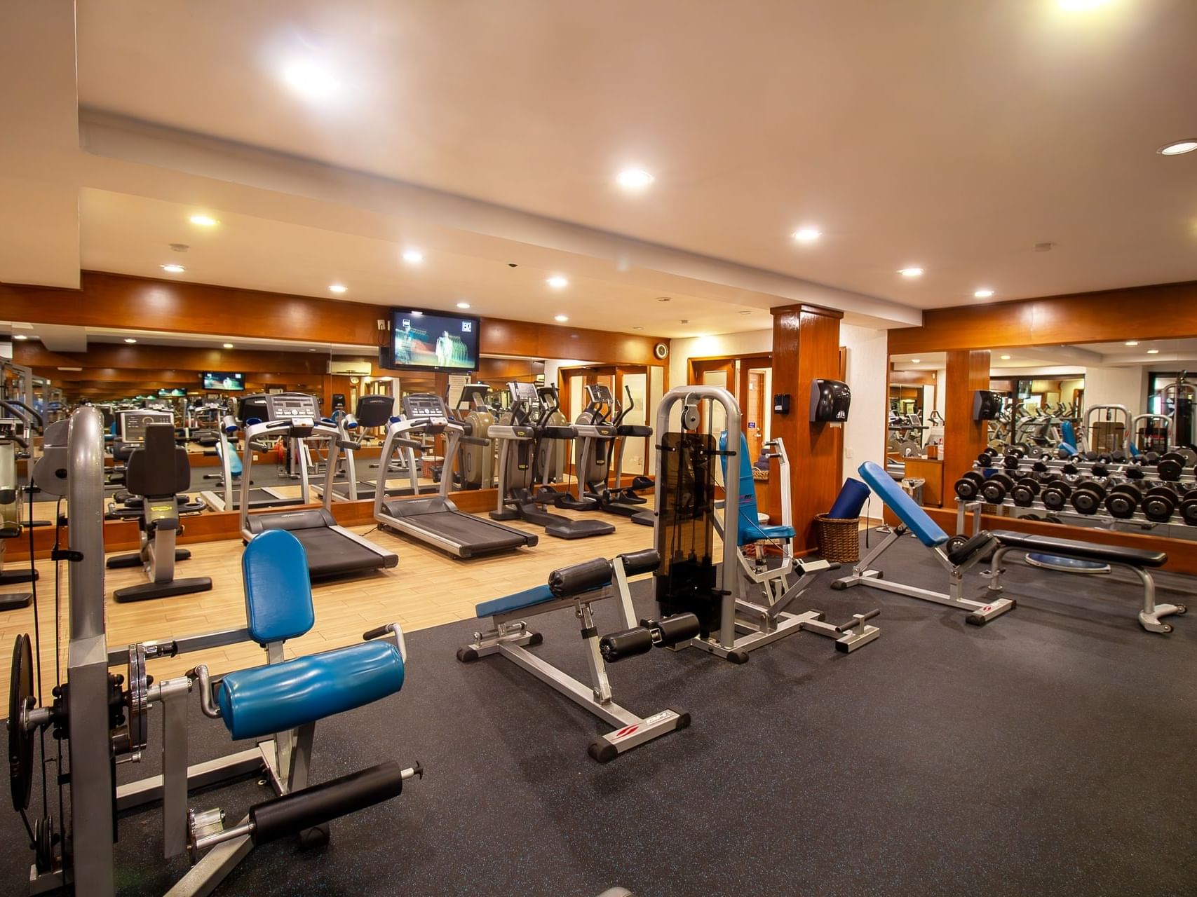 Interior view of fully equipped gym at Plaza Pelicanos Grand Beach Resort