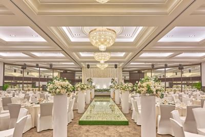Grand ballroom set up for a wedding with a sparkling aisle and floral arrangements at Goodwood Park Hotel