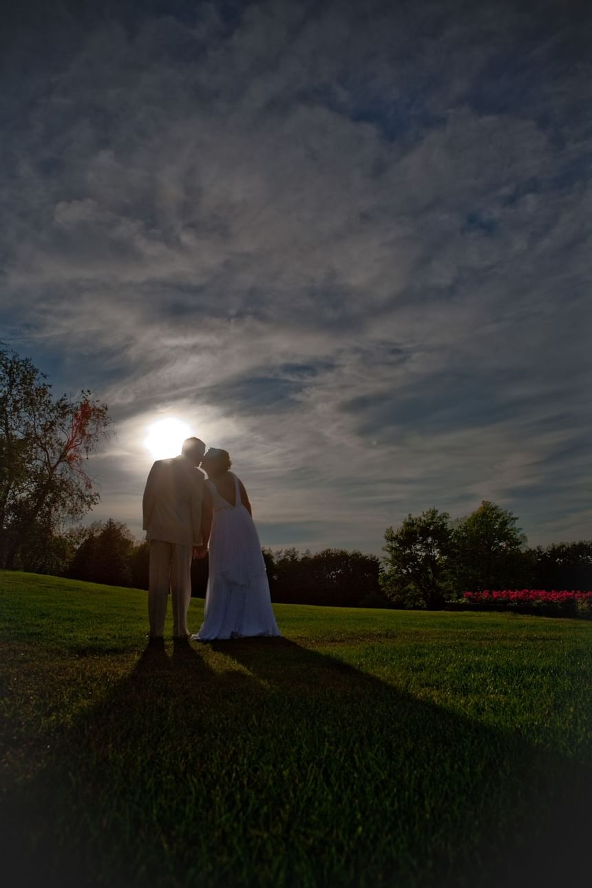Wedding couple kissing in the grounds of Evergreen Resort 