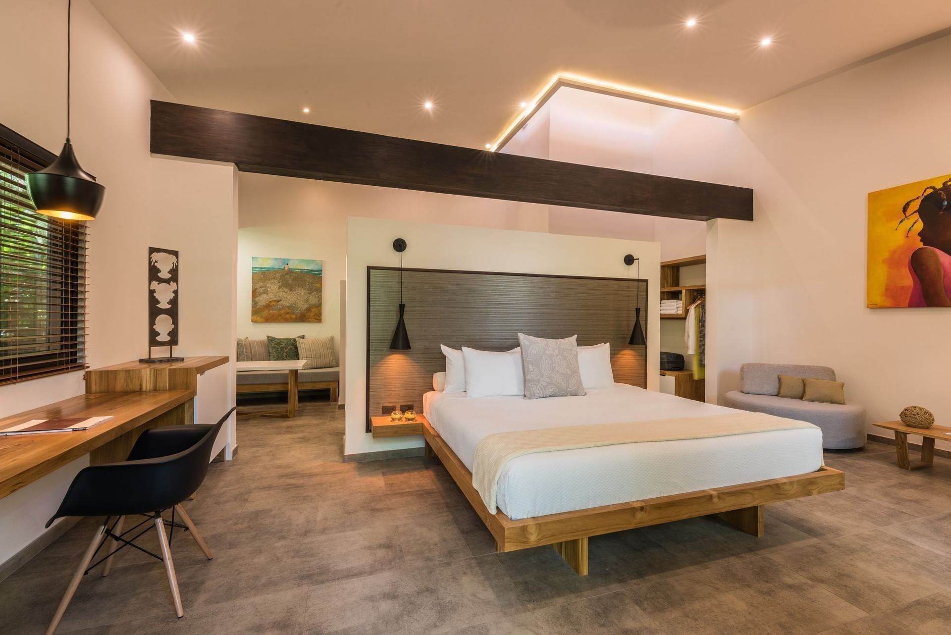 Elegant bedroom with large bed and modern furniture at Cala Luna Boutique Hotel