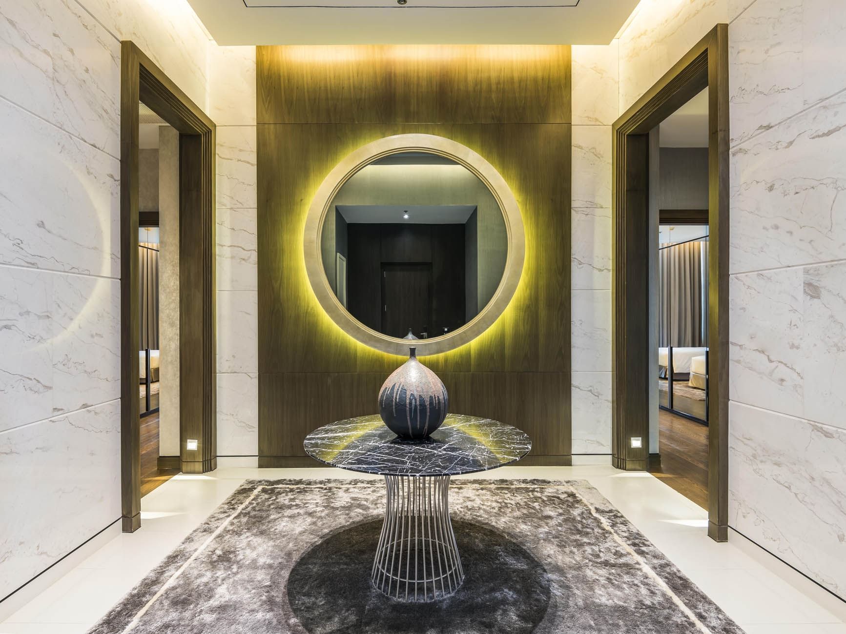 A hallway with a mirror on a wall, Emporium Suites by Chatrium