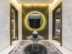 A hallway with a mirror on a wall, Emporium Suites by Chatrium