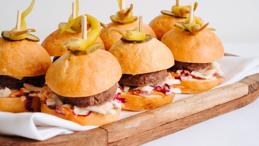 Close-up of mini sliders served on a wooden platter in Freshwater Ballroom at Novotel Sydney Olympic Park