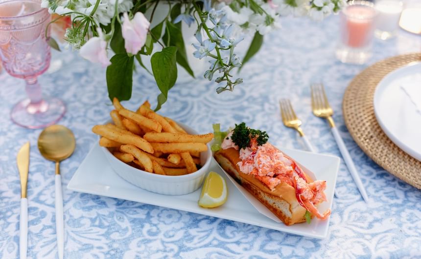 Lobster sandwich served with a side of fries at Ogunquit Collection
