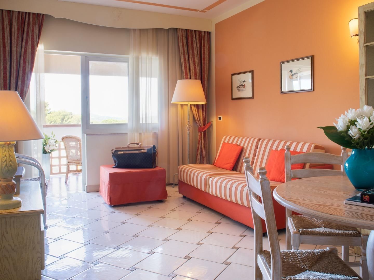 Comfy sofa and coffee table in the living area of a room at Golf Hotel Punta Ala