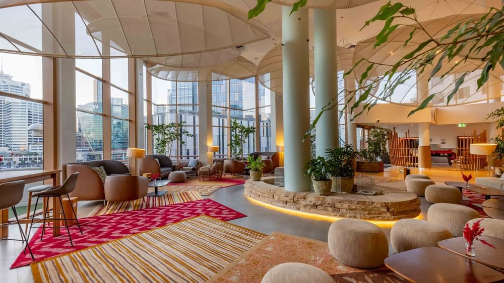 The Chemney Lounge featuring modern decor, plants, and city views at Novotel Sydney on Darling Harbour