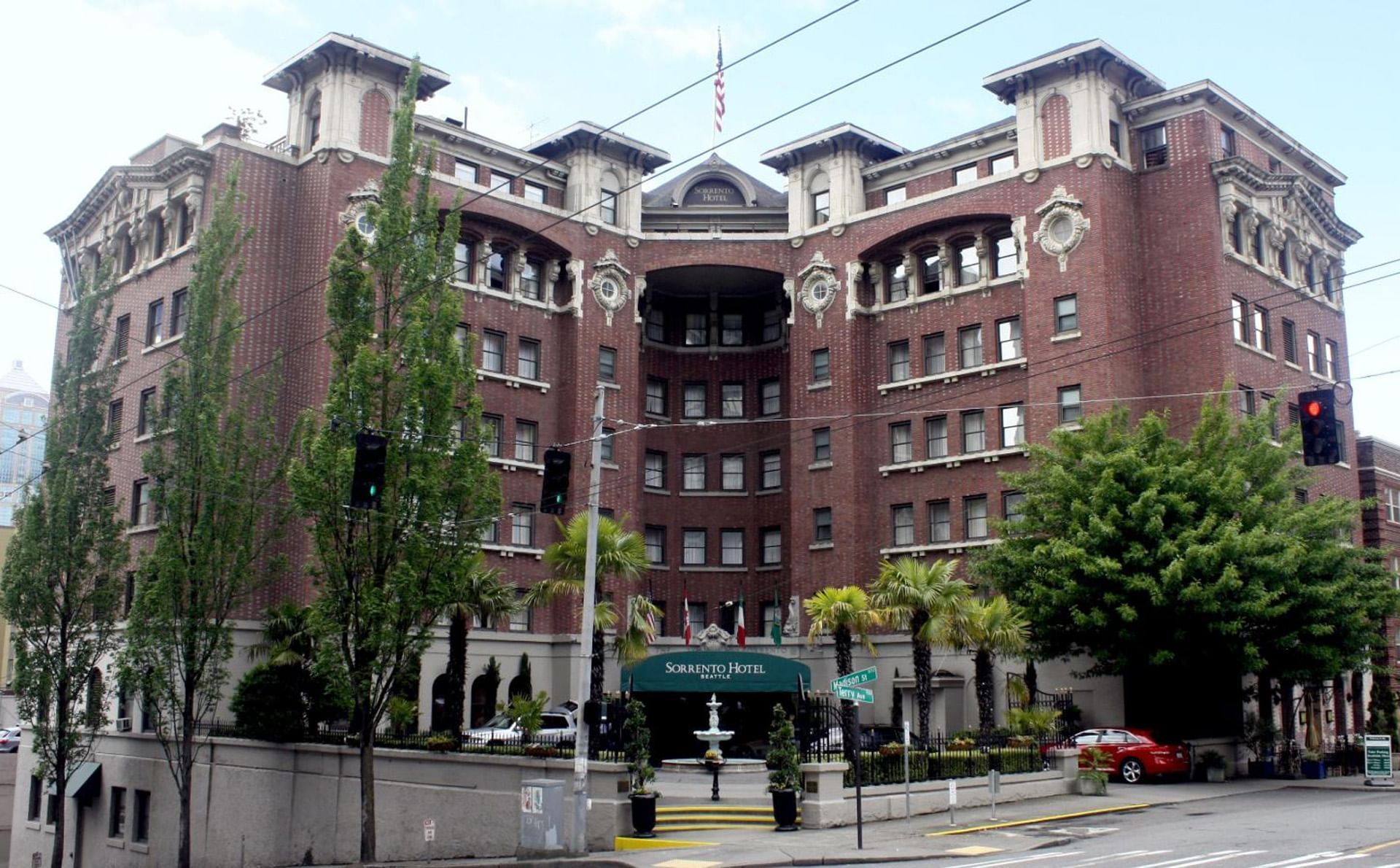 Exterior view of Hotel Sorrento with lush trees in the foreground