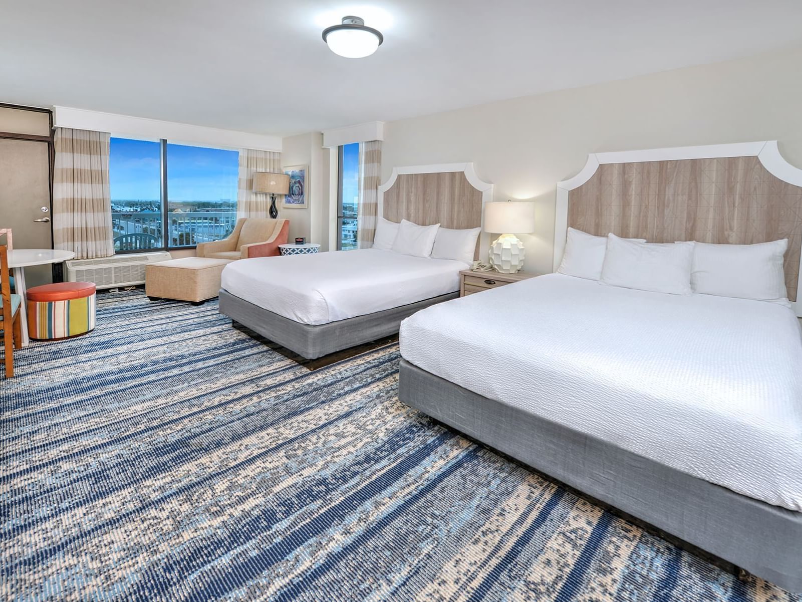 Two beds in a room with a kitchenette at Bahama House in Daytona Beach.