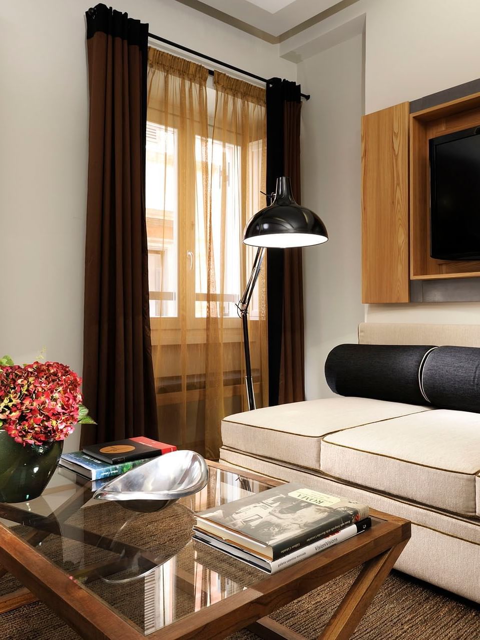 Cozy sofa arranged with TV in the living area of Classic Suite at Babuino 181
