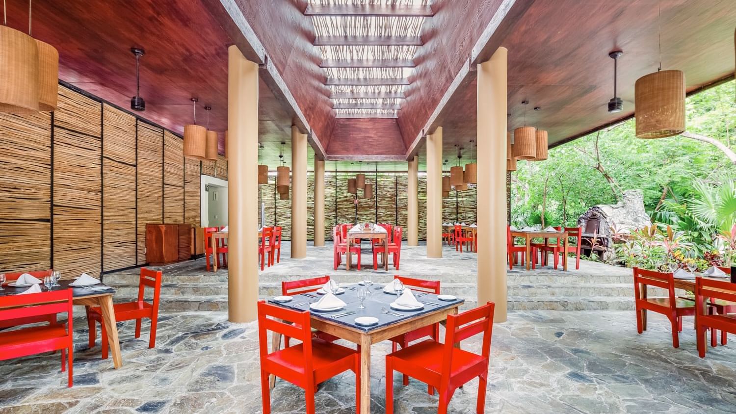 Dining tables arranged, overlooking the forest at The Explorean Cozumel