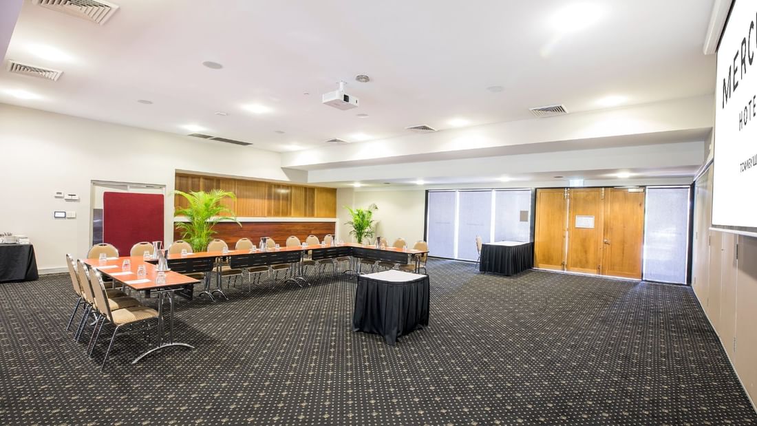 Burdekin Room with u-shape table set, chairs and large windows at Mercure Hotel Townsville