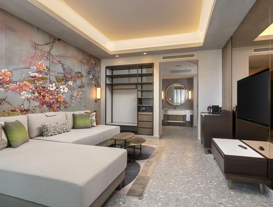 TV lounge area with a tea corner, white sofa & floral wall art, in Family Room at Cullinan Belek