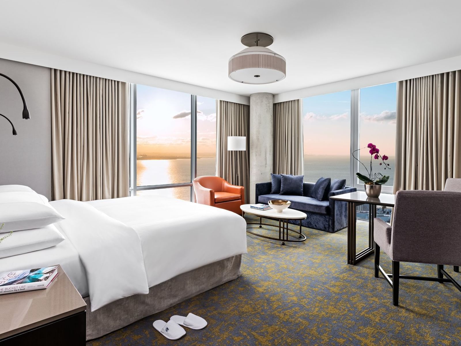 Bed with seating area, workspace and sea view in Family Two Bedroom at Hotel X Toronto