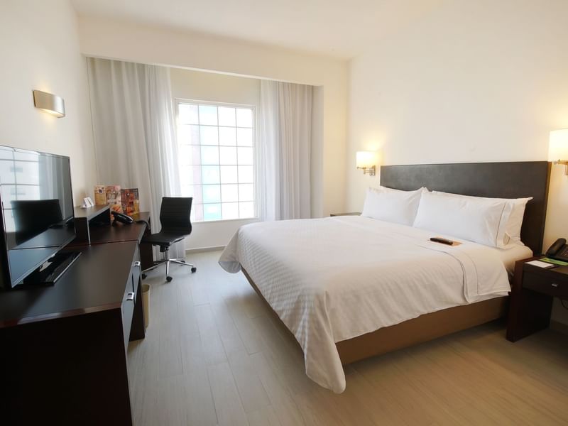 King bed with working desk in Superior Room at Fiesta Inn