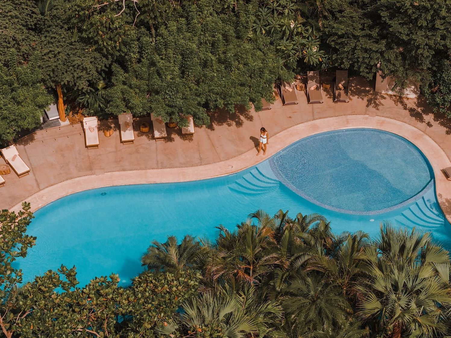 An aerial view of a large swimming pool at the Cala Luna Hotel Boutique in Costa Rica.