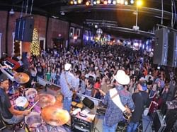 A band performs to a large crowd of people in Banita Creek Hall near The Fredonia Hotel