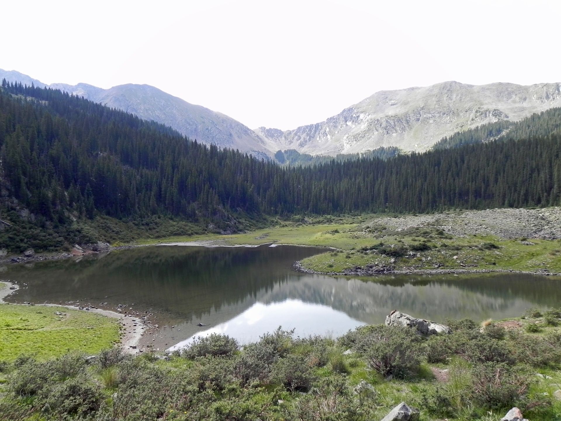 Lake surrounded by vast land and mountains