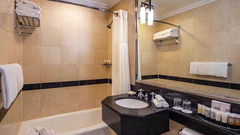 Bathroom vanity with bathtub in Premier City View Suite at Warwick New York