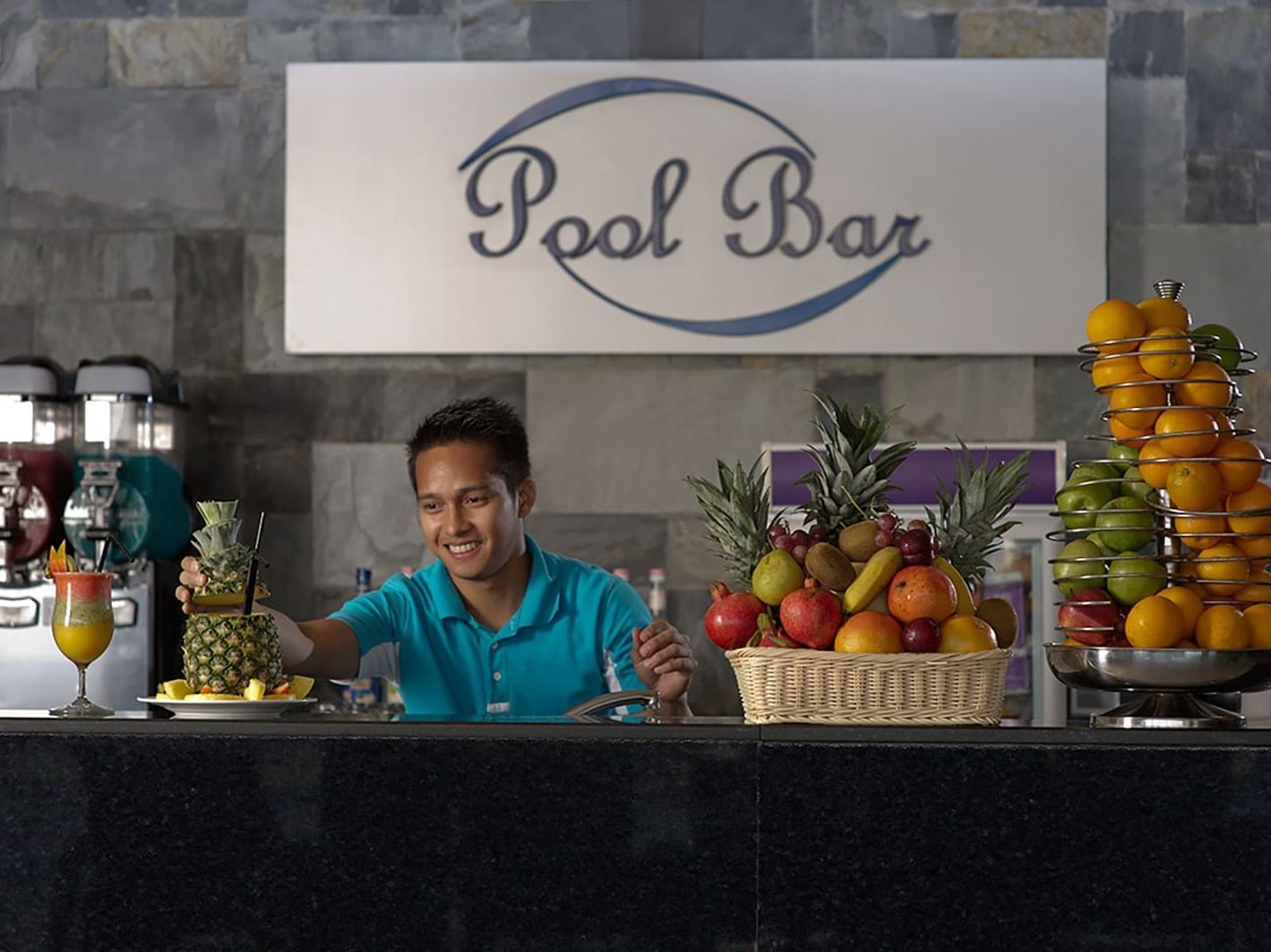 Barman making a drink in Pool bar at Two Seasons Hotel & Apt