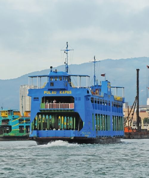 Blue ferry on the ocean with mountain view near Sunway Hotel Georgetown