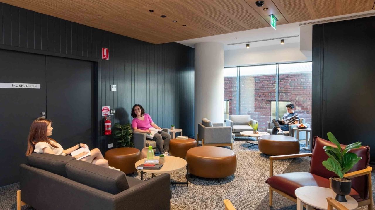Residents seated in a large communal lounge area