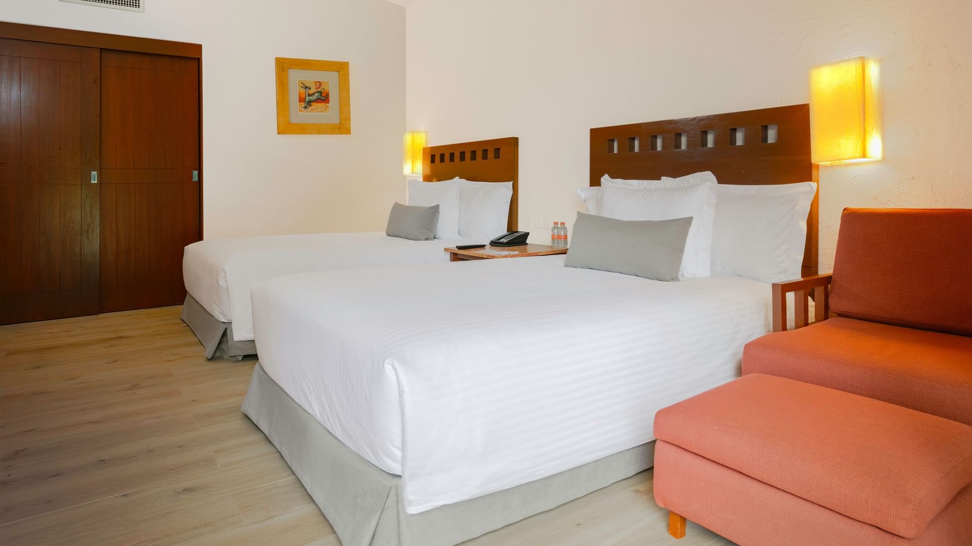 King Real Suite at Camino Real Guadalajara hotel in Zapopan with two beds, a couch, and a chair