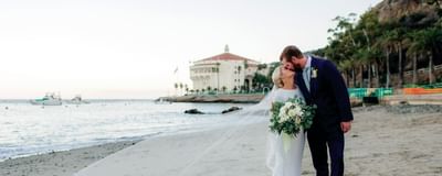 Newly wedded couple strolling on the beach at Catalina Island Company