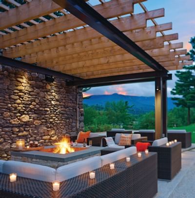 Outdoor seating area with a firepit at Topnotch Stowe Resort
