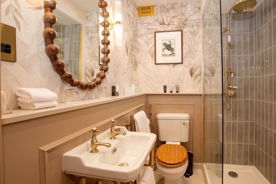 One Bedroom Apartment bathroom with vanity and glass shower at The Capital Hotel, Apartments and Townhouse