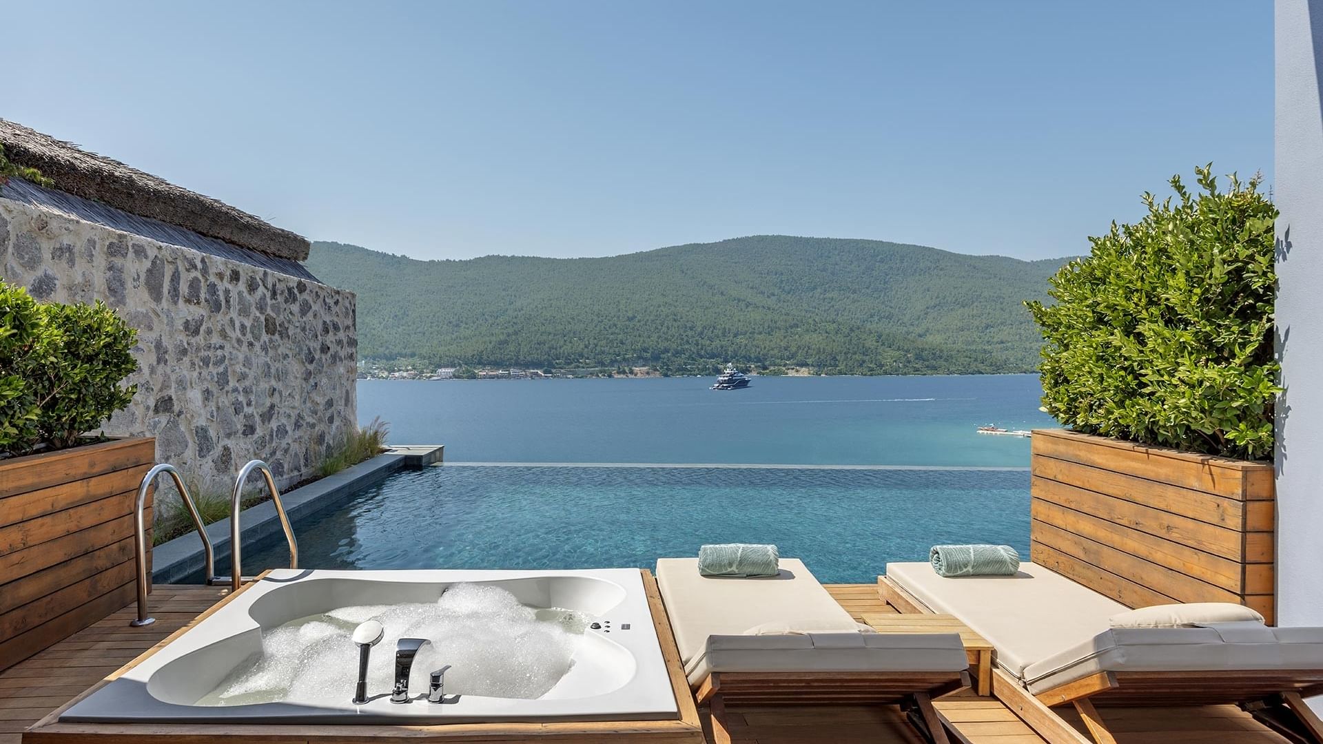Private terrace of the Exclusive Swim-up Room overlooking the pool at Titanic Luxury Collection Bodrum