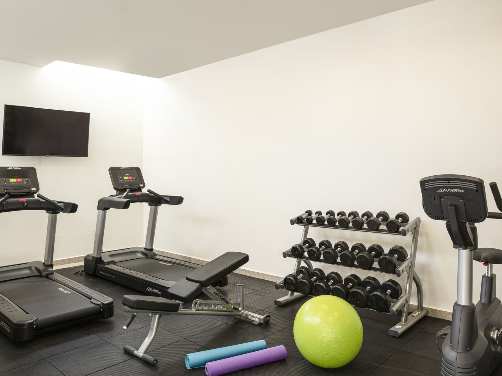 Exercise machines in a Gym wellness center at Fiesta Inn Hotels