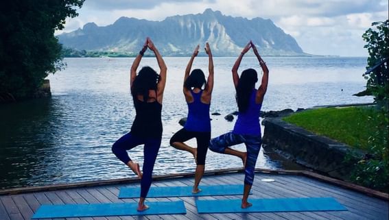 Ladies doing yoga overlooking the sea at  Paradise Bay Resort