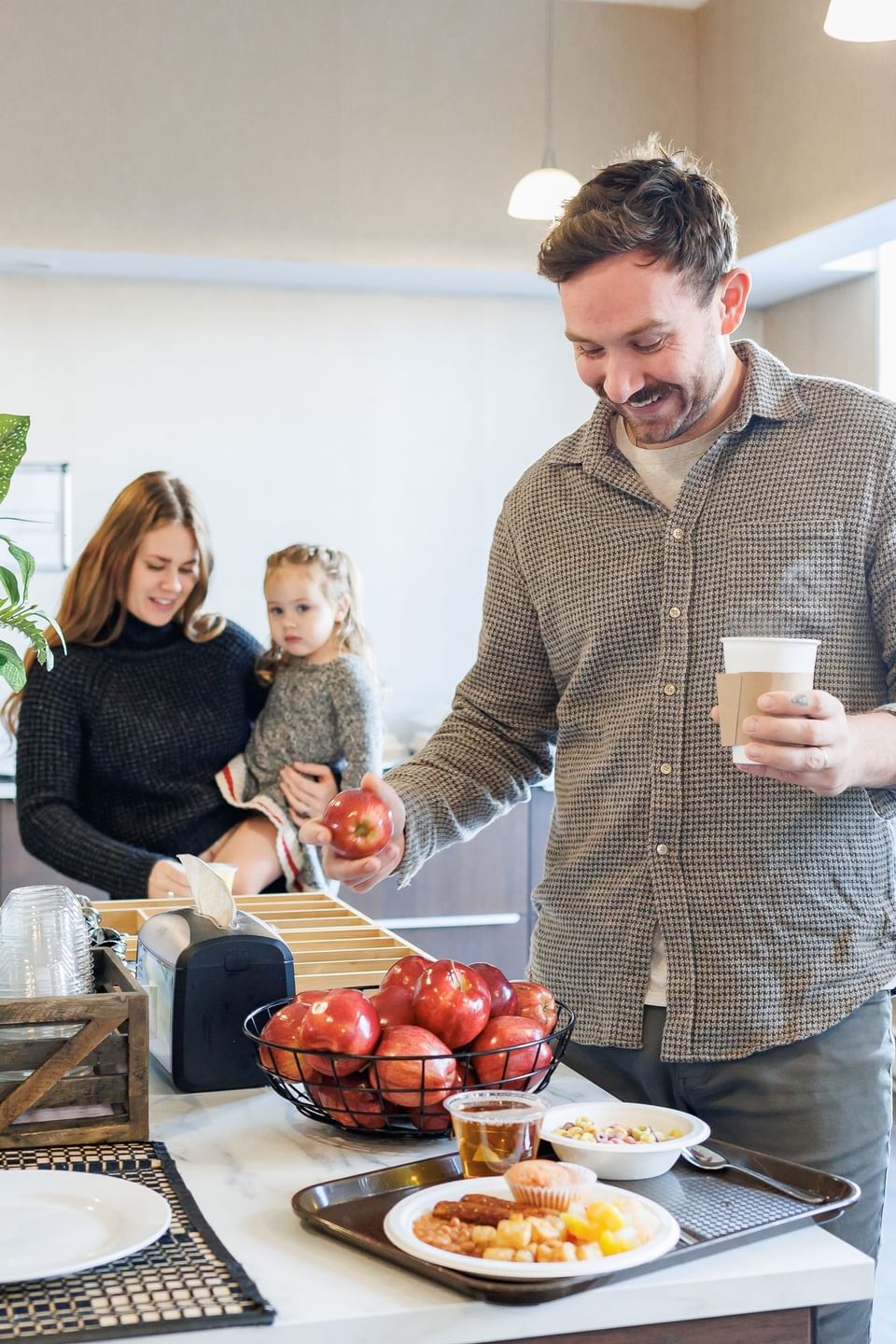 Family selects breakfast items at Rodd Royalty, providing a comfortable home base for Charlottetown accommodations