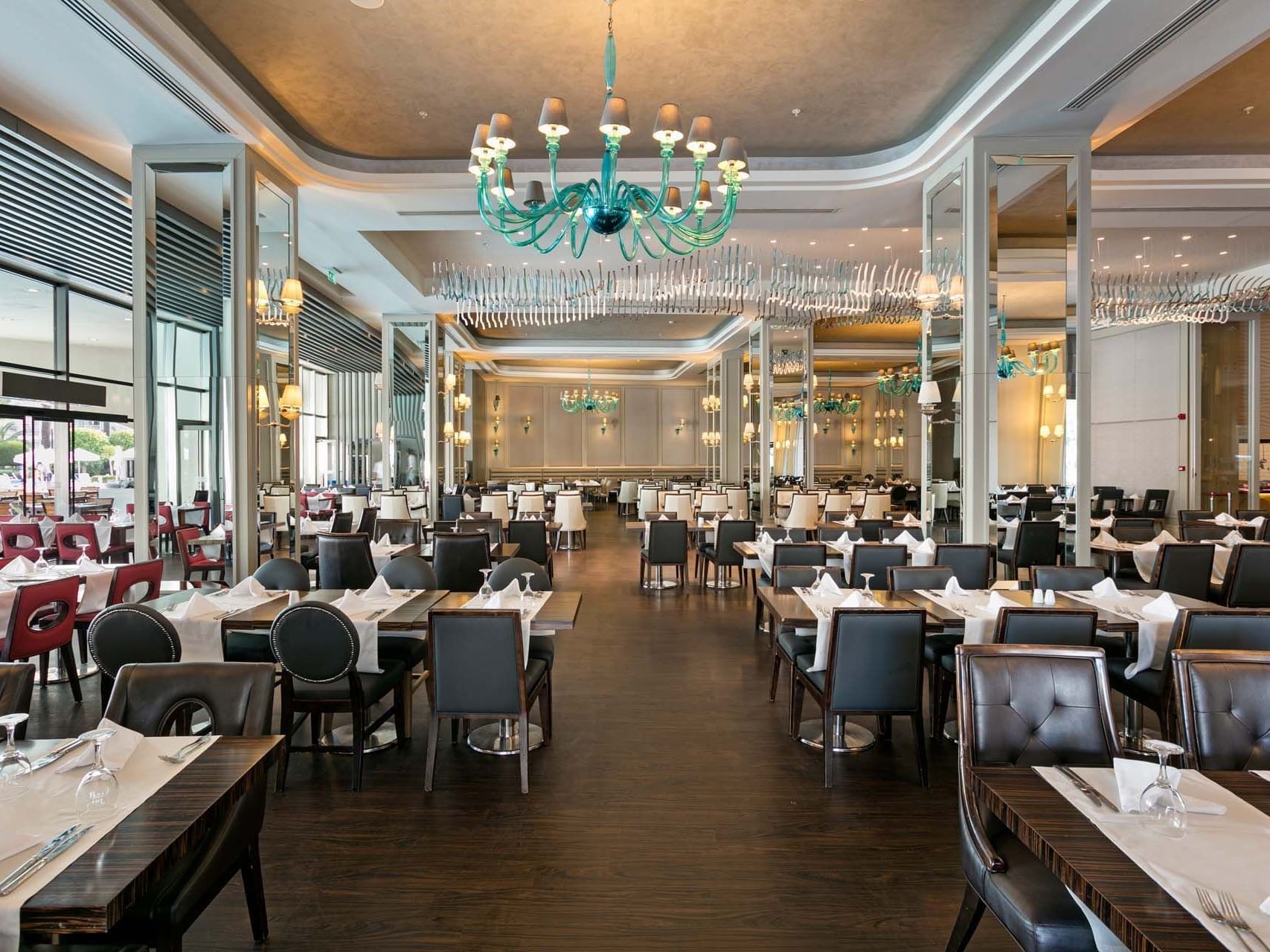 Dining tables and chairs arranged elegantly in Parkfora Main Restaurant at Titanic Deluxe Lara