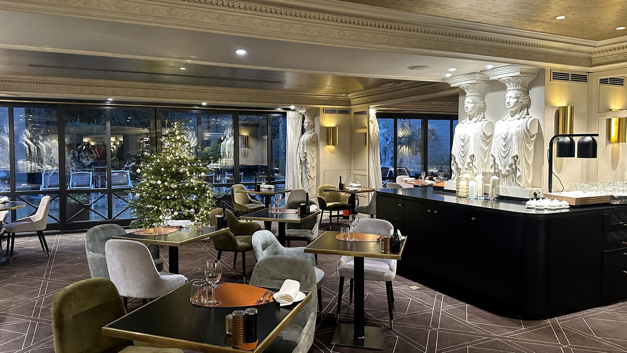 Dining area with set up tables and adorned with Christmas decors in The Avenue at Hotel Barsey by Warwick - Brussels