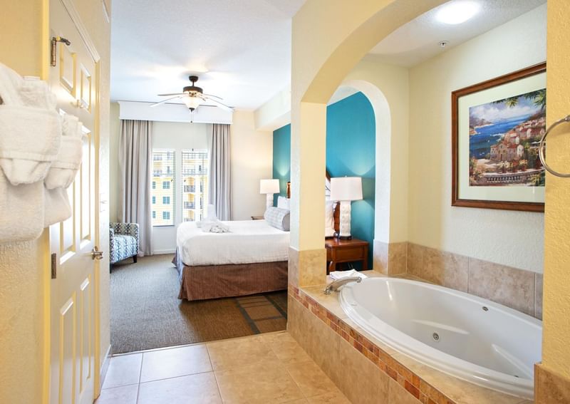 Master Room with cozy bed and jacuzzi tub at Lake Buena Vista Resort Village & Spa