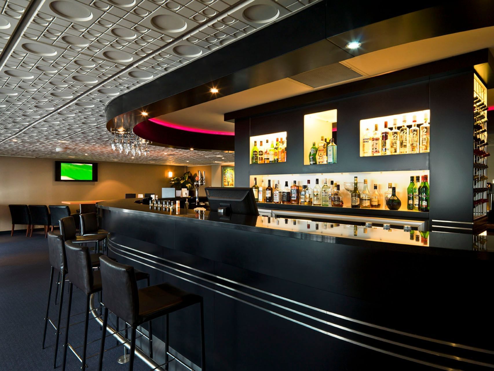 Bar shelves with liquor bottles in Whitby's Restaurant & Bar at James Cook Hotel